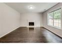 Inviting living room features a fireplace and stylish dark hardwood floors at 7006 Mahonia Place, Stonecrest, GA 30038