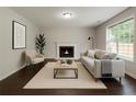 Bright living room with fireplace, hardwood floors, and natural light at 7006 Mahonia Place, Stonecrest, GA 30038