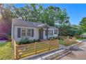 Charming home featuring a cozy front porch and fenced yard at 845 Oak Nw St, Atlanta, GA 30318