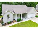 Beautiful single-story home boasting a painted brick front, covered entrance, attached garage, and green lawn at 9691 Squirrel Wood Run, Douglasville, GA 30135