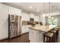 Modern kitchen featuring stainless steel appliances, granite countertops, and a spacious island with seating at 1896 Grove Field Ln # 29, Marietta, GA 30064
