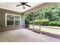 Relaxing screened patio area with concrete flooring and outdoor ceiling fan, perfect for entertaining at 1896 Grove Field Ln # 29, Marietta, GA 30064