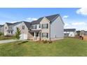 Charming two-story home with well-kept lawn on a sunny day in residential neighborhood at 281 Sandy Oak Dr, Loganville, GA 30052