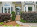 Inviting front entrance with stone steps, lush landscaping and arched windows on this lovely home at 310 Arbor Creek Trl, Roswell, GA 30076
