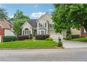 Charming two-story home with manicured lawn, mature trees, and a well-maintained front yard at 310 Arbor Creek Trl, Roswell, GA 30076