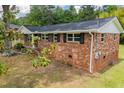 Side view of the brick house showing windows, shutters and landscaping at 6213 Cherry Ln, Douglasville, GA 30134