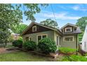 Charming craftsman-style home with a well-maintained lawn and lush landscaping at 628 Home Se Ave, Atlanta, GA 30312
