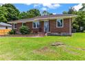 Charming brick ranch with a well-manicured lawn and inviting front entrance at 821 Springvalley Dr, Forest Park, GA 30297