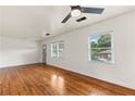 Bright living room with gleaming hardwood floors and natural light from large windows at 821 Springvalley Dr, Forest Park, GA 30297