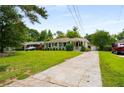 Quaint one-story home with a manicured front lawn, long driveway and inviting covered porch at 2288 Scotty Cir, Decatur, GA 30032