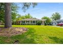 Beautiful front yard featuring a lush lawn, mature trees, and a well-maintained exterior with covered porch at 2288 Scotty Cir, Decatur, GA 30032