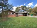 Charming brick home with a well-maintained lawn and a convenient covered carport at 3098 Henderson Mill Rd, Atlanta, GA 30341