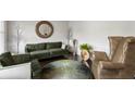 Cozy living room featuring plush sofas, a round mirror, and decorative accents for a comfortable setting at 7207 Gladstone Cir, Stonecrest, GA 30038