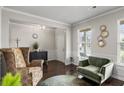 Comfortable living room with stylish armchairs, modern decor, and natural light from a window at 7207 Gladstone Cir, Stonecrest, GA 30038