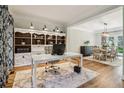 Stylish home office with custom built-ins and wood floors, adjacent to the formal dining room at 1006 Amberton Ln, Powder Springs, GA 30127