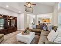 Spacious living room with a vaulted ceiling, large sectional sofa, and open access to the dining area at 1006 Amberton Ln, Powder Springs, GA 30127