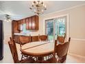 Cozy dining room featuring wood table and chairs and backyard views through sliding glass doors at 1739 Brandy Woods Se Trl, Conyers, GA 30013