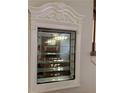 A mirrored display cabinet with glass shelves is an elegant storage solution at 1739 Brandy Woods Se Trl, Conyers, GA 30013