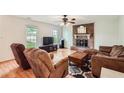 Inviting living room with a cozy fireplace, hardwood floors, and plenty of natural light at 1739 Brandy Woods Se Trl, Conyers, GA 30013