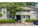 Attractive home exterior with mature trees, manicured bushes, and a convenient parking area at 3428 Ivys Walk, Atlanta, GA 30340