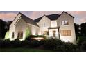 Elegant brick home with stylish dark roof, well-kept landscaping, and sophisticated outdoor lighting at 3680 Tanglewood Se Dr, Atlanta, GA 30339