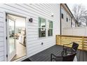 Inviting deck with outdoor seating, offering a relaxing space for outdoor enjoyment, and a glimpse of the living room at 586 Avondale Park Cir, Decatur, GA 30032