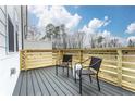 Stylish deck with black metal chairs, wooden railings, and a serene view, creating a perfect outdoor retreat at 586 Avondale Park Cir, Decatur, GA 30032