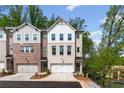 Townhome community featuring attached garages, sidewalks, and professionally landscaped lawns at 586 Avondale Park Cir, Decatur, GA 30032
