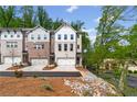 Townhome community with professionally landscaped yards, driveways, and single-car garages at 586 Avondale Park Cir, Decatur, GA 30032