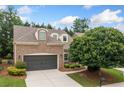 Attractive home with a two-car garage, brick facade, and manicured landscaping at 123 Meridian Dr, Woodstock, GA 30188