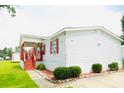 Manufactured home featuring a covered front porch, tidy landscaping, and paved driveway at 263 Gulfport Ct, Hampton, GA 30228