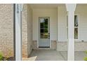 Elegant front door with glass panels framed by brickwork and white columns at 158 Palisade Dr, Rydal, GA 30171