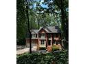 Beautiful brick home with lush landscaping and a two-car garage, nestled among mature trees at 1915 Habersham Trce, Cumming, GA 30041