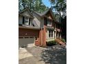 Brick home with an attached garage and a well-manicured landscape, offering a welcoming curb appeal at 1915 Habersham Trce, Cumming, GA 30041