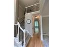 Two-story foyer with hardwood floors, neutral paint, and stairs with iron railings at 1915 Habersham Trce, Cumming, GA 30041