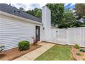 Side exterior view with a white fence and a pathway leading to the entrance at 214 Chelsea Ct, Woodstock, GA 30189