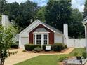 Exterior showing home with red brick accent wall, bay window, and manicured landscaping at 214 Chelsea Ct, Woodstock, GA 30189