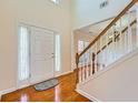 Welcoming entryway featuring a high ceiling, white door with sidelights, and beautiful hardwood flooring at 1713 Paramore Ne, Marietta, GA 30062