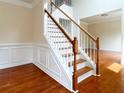 Elegant staircase with wood treads, white risers and trim, and decorative wainscoting at 1713 Paramore Ne, Marietta, GA 30062