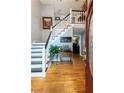 Elegant foyer showcases hardwood floors, staircase with white banister and black railing, and stylish decor at 2050 Lyda Ln, Loganville, GA 30052