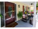 Charming front porch featuring rocking chairs and decorative plants, creating a welcoming outdoor living space at 2050 Lyda Ln, Loganville, GA 30052