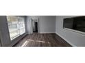 Dining room featuring hardwood floors, natural light, and a pass-through to the kitchen at 70 Ruzelle Se Dr, Atlanta, GA 30354