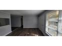 Bright living room with hardwood floors and neutral paint; door leads to exterior, pass through to kitchen at 70 Ruzelle Se Dr, Atlanta, GA 30354
