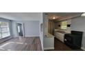 Living room and kitchen with tile and hardwood floors and neutral paint at 70 Ruzelle Se Dr, Atlanta, GA 30354