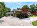 View of the exterior of the house with mature trees, a large driveway and an outbuilding at 3778 Berdon Ln, Decatur, GA 30034