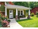 Inviting front porch with seating, perfect for relaxing outdoors with nice landscaping at 3778 Berdon Ln, Decatur, GA 30034