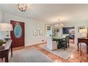 The dining room has hardwood floors, a modern chandelier, and light green walls at 3812 Chattawood Dr, Duluth, GA 30096