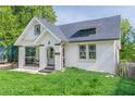 Charming one-and-a-half-story home with white painted brick, black trim and a covered porch with arched entryway at 975 Dill Sw Ave, Atlanta, GA 30310