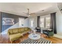 A living room with hardwood floors, modern decor, and a decorative accent wall at 975 Dill Sw Ave, Atlanta, GA 30310