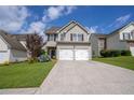 Inviting two-story home with a two-car garage, blue accents and a well-manicured lawn at 4135 Arch Pass, Cumming, GA 30040